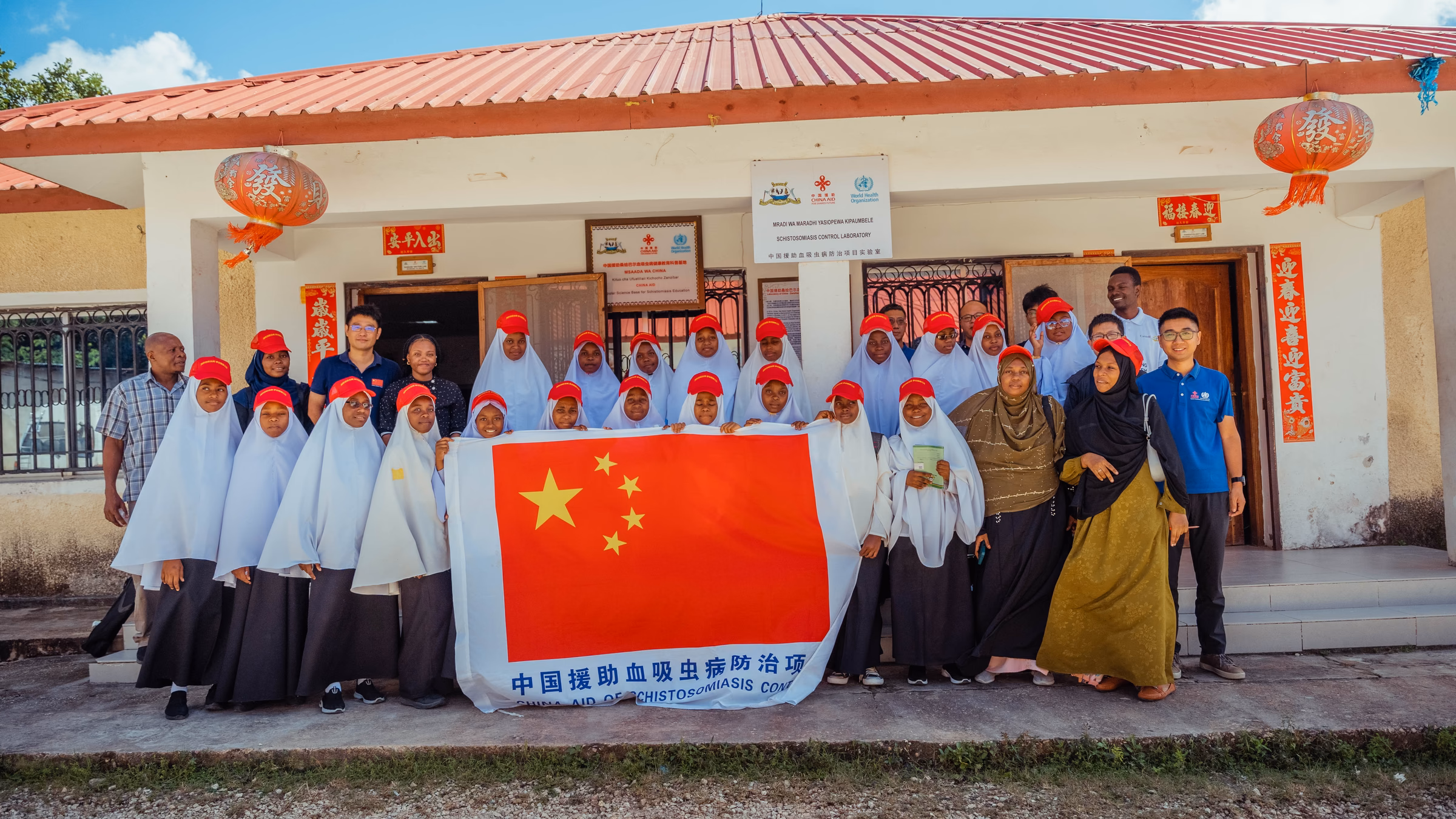 Students, educators and visitors gathered outside the Schistosomiasis Control Laboratory in Pemba