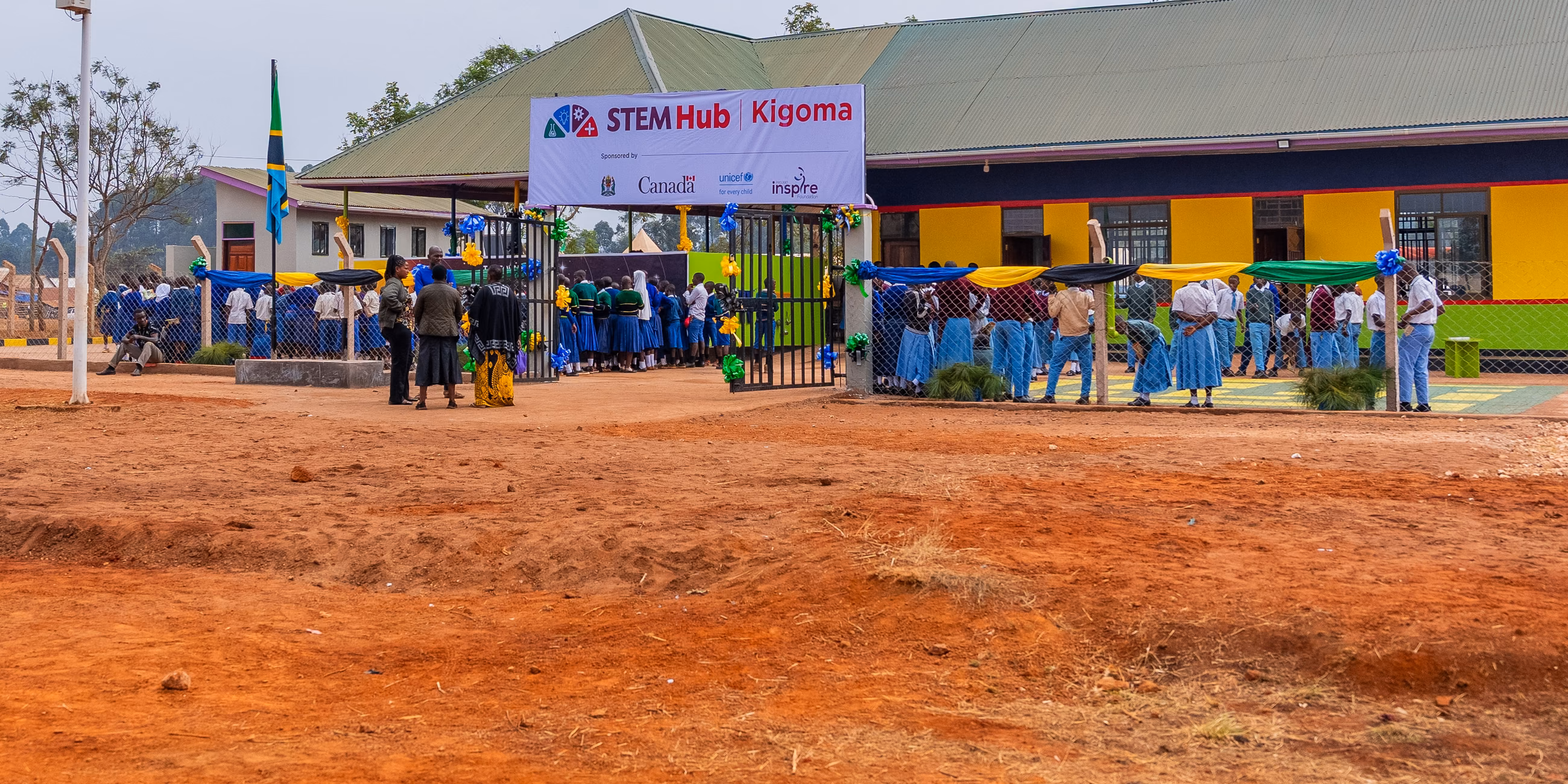 Students and community members gathered outside the colourful STEM Hub Kigoma building