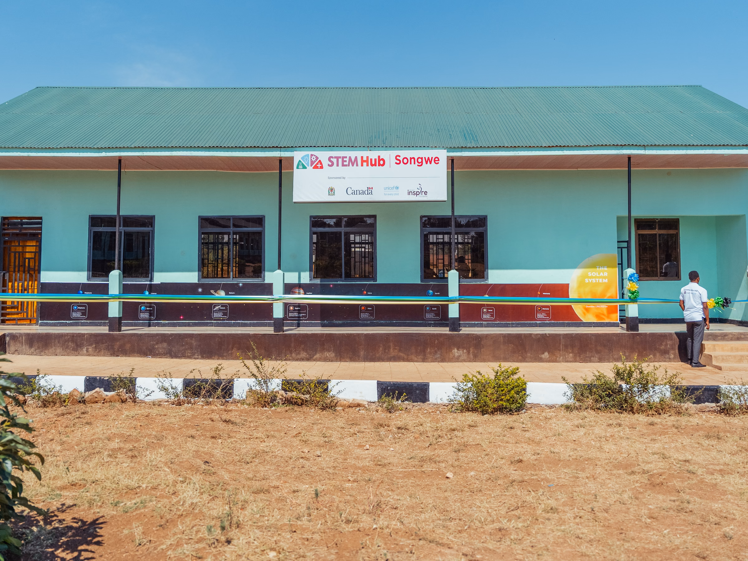 The STEM Hub Songwe building with its outdoor solar-system learning display
